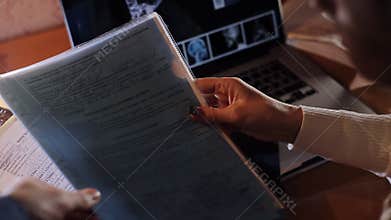 Doctor looking at an x-ray, medical records laptop