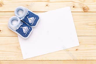 Baby announcement card with baby blue shoes.