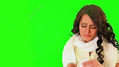 Cold girl blowing his nose on green screen.