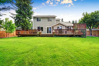 Back yard house exterior with spacious wooden deck