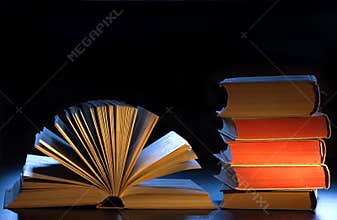 Stack books, open book and copyspace.