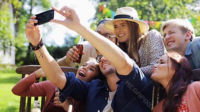 Friends taking selfie at party in summer garden