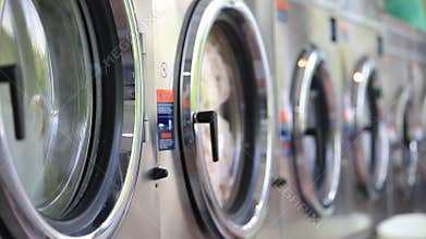 Washing machines at laundry washes colored clothing, and sheets