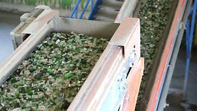 Glass waste in recycling facility. Glass particles in a machine. Line
