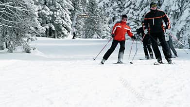 Group of older people enjoy skiing in winter