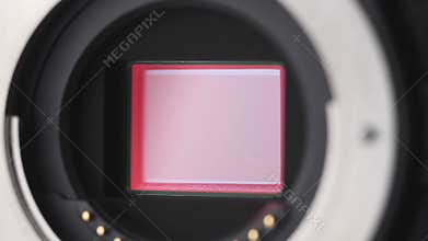 Open mirrorless digital Camera shows shutter mechanism close up.