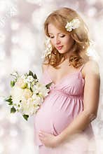 Pregnant woman looking at belly