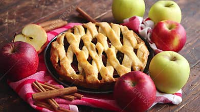 Homemade pastry apple pie with bakery products on dark wooden kitchen table