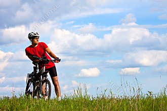 Young bright man on mountain bike