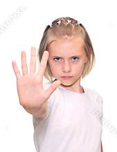 Little girl is makes a stop gesture