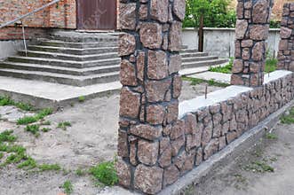 Building under construction house fence from natural stone