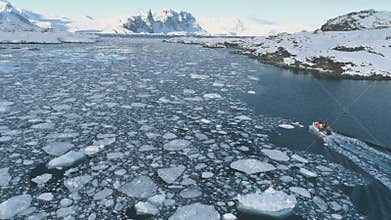 Zodiac boat in Antarctica ocean aerial shot