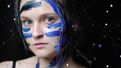 Artistic face paint woman blue warrior makeup