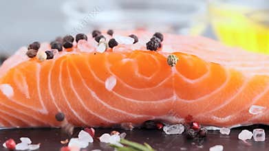 Raw salmon fillet on a slate board.