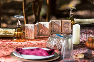 Closeup shot of a reception table set and decorated for the groom and bride with Mr. and Mrs. sign