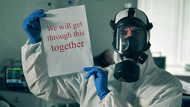 Medical worker in a clinic unit is showing an encouraging note. Coronavirus COVID-19 comcept.