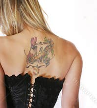 Blond Woman In Corset With Back Tattoo