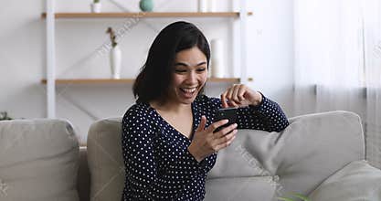 Asian female received sms feels excited scream with joy