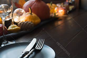 Fall dark place setting with pumpkins, autumn harvest. Thanksgiving Day. Close up