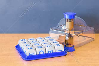 Boggle Board Game on the wooden table. 3D rendering