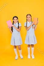Literacy club. Cute children holding books on yellow background. Little girls with encyclopedia or childrens books