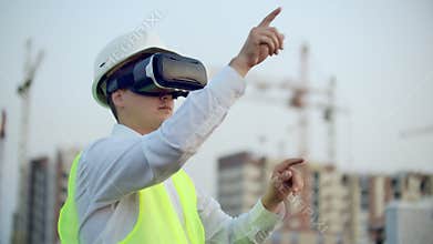 A Worker on Construction site with VR glasses smart city.