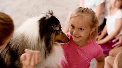 Happy kids playing with therapy dog