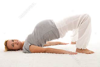 Pregnant woman doing exercises on the floor
