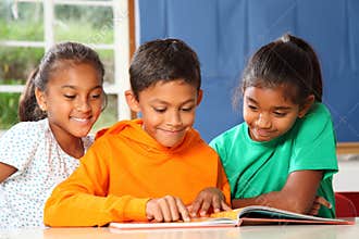 Primary school children in class reading learning