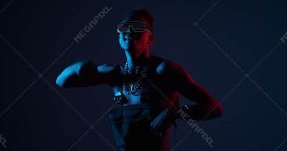 Shirtless man dancing at rave party