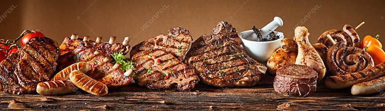 Selection of grilled gourmet meats on timber