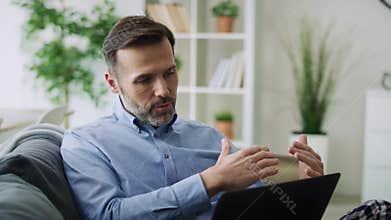 Video of man gesturing during a video conference.