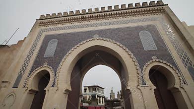 BEAUTIFUL OLD ARCHWAY, GATE IN MOROCCO OLD TOWN WITH BIRDS PASSING BY IN THE SKY
