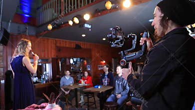 Videographer recording woman giving talk