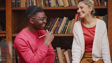 Happy and smiling college friends studying together