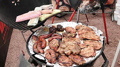 Barbecue grill with sausages, chicken breasts, beef and pita bread for kebab