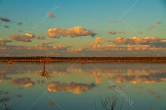 Blue sky with clouds with reflections in a lake