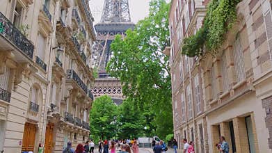 PARIS, FRANCE - JUNE 12, 2023. Tourists on the old street close to the Eiffel Tower