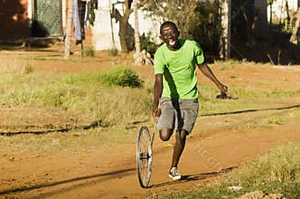 Youngster Playing with Wheel Rim