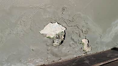 The walls of the old building are cracked, poorly repaired, with peeling paint