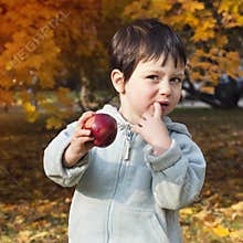 Autumn child with apple