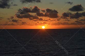 Golden Ocean Sunset with Dramatic Clouds on the Horizon
