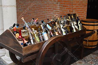 Assorted Liquor Bottles Displayed on Rustic Wooden Cart