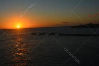 Vibrant Ocean Sunset with Fiery Orange Sky and Clouds