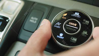 A detail with a sport mode switch in the car. Button for manual selection of sport, eco, comfort driving modes on a