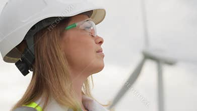 Planning for a sustainable future: A female designer considers wind turbine positioning. Wind energy in focus: an