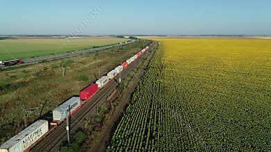 Aerial view of A2 Highway motorway road and a cargo train transporting Maerks and MSC shipping containers.