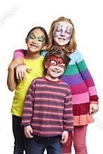 Young boy and two girls with face painting of cat, butterfly and