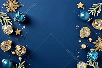 Christmas card. Frame borders made of gold balls, decorations, fir branches on dark blue background. Luxury style