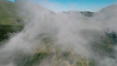 Cinematic drone shot flying over country road with curved in the mountain